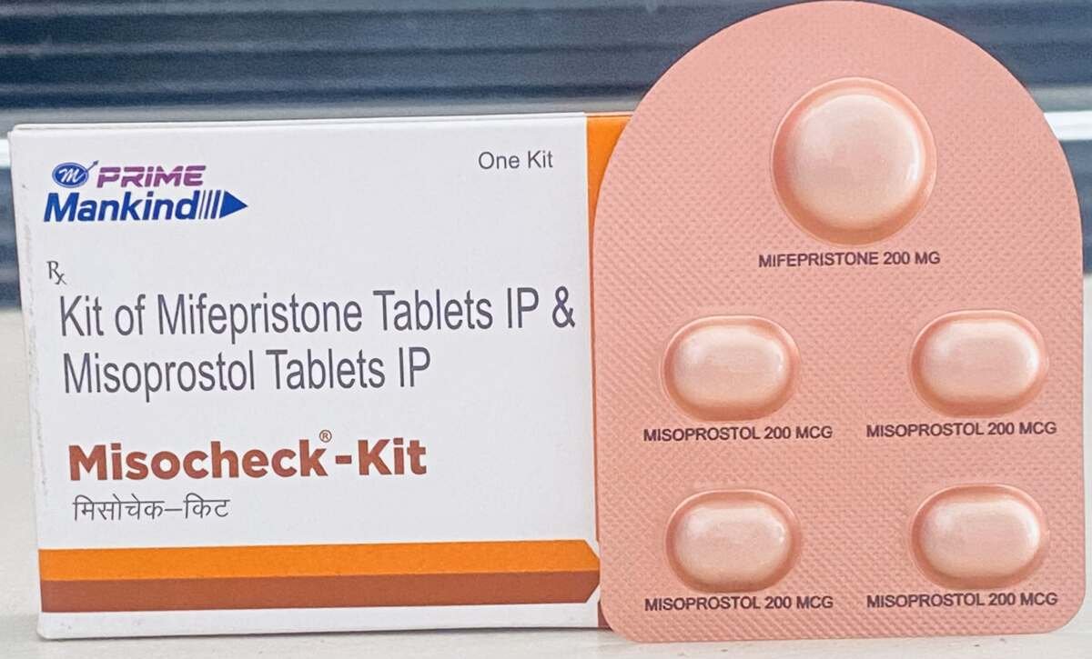 Abortion Clinic table Mifepristone Misoprostol tablet female doctor behind medicine